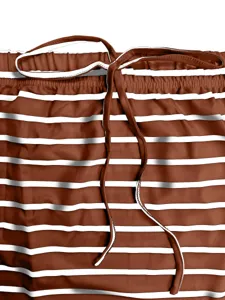 Brown and white striped garment detail closeup, elastic waistband with adjustable drawstring.