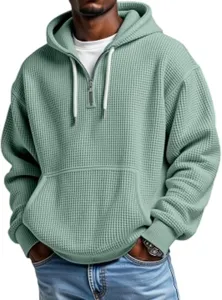 Men's waffle knit quarter zip hoodie detail showing textured fabric and drawstring hood.