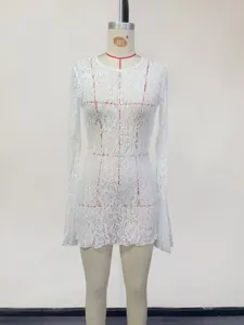 Detailed view of the elegant white lace long-sleeve women's beach cover-up and sun protection.