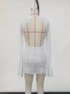 Back detail of white lace beach dress cover-up, elegant hollow-out design for summer wear.