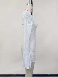 Detail view of white lace beach dress cover-up sleeve showing floral pattern texture.