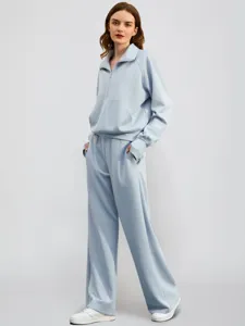 Light blue half-zip sweatshirt and wide-leg sweatpants two-piece active tracksuit set.