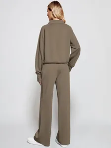 Detail view of back design, casual two-piece tracksuit with half-zip sweatshirt and wide pants.
