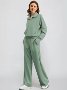 Detailed view of the stylish half-zip sweatshirt and wide-leg casual tracksuit set.