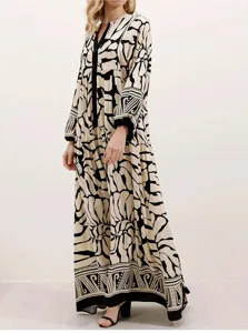Detailed view of the elegant long sleeve maxi dress featuring unique abstract print design.