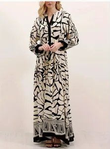 Detail view of long sleeve maxi dress featuring black and white abstract print and button placket.