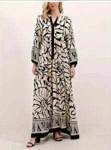 Elegant long sleeve maxi dress featuring a chic black and beige abstract pattern.
