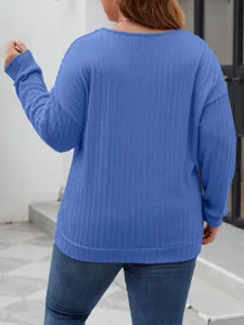 Close-up detail of the blue vertical stripe cable knit sweater showcasing soft texture and comfortable fit.