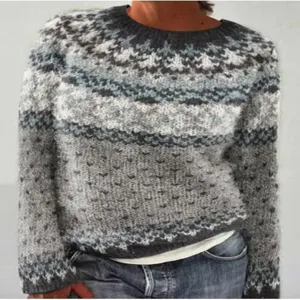 Detailed view of women casual crewneck knitted sweater with nordic geometric pattern.