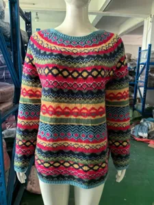 Detailed view of the colorful geometric pattern knitted sweater, featuring a classic round neck.