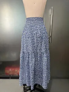 High-waisted tiered long skirt featuring a charming blue and white floral print and elastic waist.