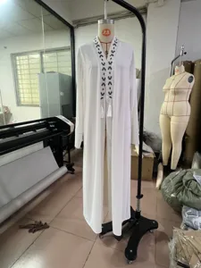 White long sleeve cardigan with black embroidery detail and tassels for women fashion wear.