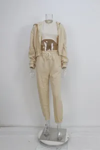 Detail view of the beige 3-piece fleece-lined tracksuit set featuring hoodie and sweatpants.