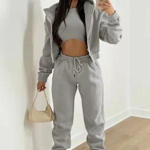 Grey women 3-piece tracksuit detail view featuring cozy fleece-lined hoodie, crop top and pants.