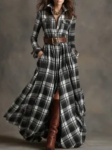 Detailed view of women's black and white plaid long sleeve shirt dress with chic belt styling.