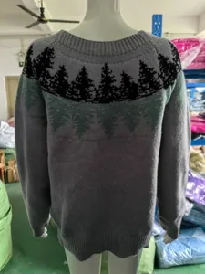 Grey crewneck knit sweater with black and green pine tree forest pattern for women.