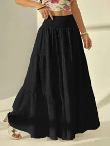 Detail shot of the stylish black maxi skirt featuring a high waist and tiered design.