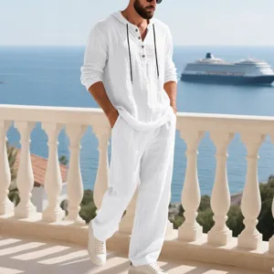 White linen hooded long sleeve shirt and pants set detail view showing fabric texture on balcony.