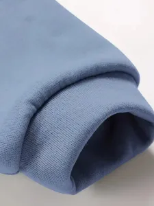 Close-up detail of the soft fleece hoodie sleeve cuff, showing premium texture and fine stitching.