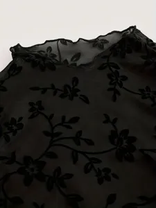 Black sheer mesh mock neck top with elegant flocked floral print, long sleeve apparel detail.