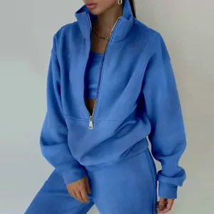 Detail view of stylish blue fleece zip-up hoodie and track pants set, casual streetwear fashion.
