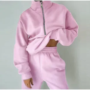 Pink fleece half zip sweatshirt and sweatpants set detail showcasing soft fabric and cozy casual style.