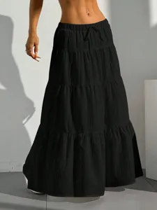 Detail view of the black tiered maxi skirt featuring a comfy drawstring waist and flared hem.