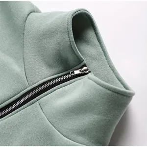 Close-up detail shot of mint green fleece zip-up sweatshirt collar and metal zipper.