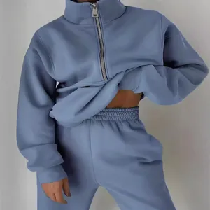 Women's half-zip fleece sweatshirt and jogger pants two-piece tracksuit set for daily wear.