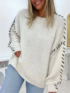 Close-up detail of women's long sleeve crewneck knit sweater with black lace-up sleeves.