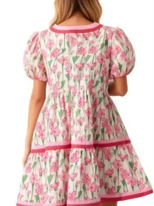 Back detail of the floral print puff sleeve tiered dress showing pink flower pattern and contrast trim.