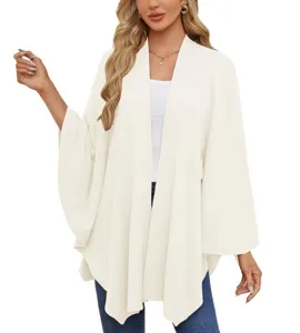 Detail view of the elegant solid color knit open-front poncho cape cardigan top for women.