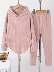 Detail view of women solid color casual hoodie and pants lounge set in pink texture.