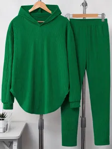 Green textured long sleeve hooded sweatshirt and matching trousers loungewear set detail view.