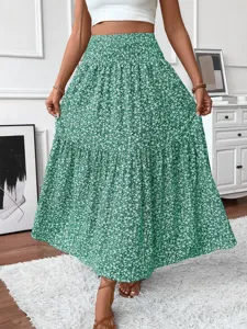 Detailed view of the green floral tiered maxi skirt, showcasing the elegant pleated high waist.