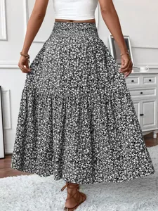 Black and white floral tiered maxi skirt with high elastic waist and elegant flowy design.