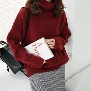 Détail de pull rouge col roulé douillet, texture en maille douce, manches longues, coupe ample.
