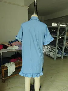 Back detail of light blue short sleeve denim dress with lettuce edge hem and lapel collar.