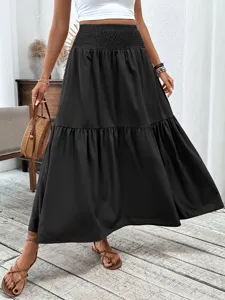 Black tiered maxi skirt detail, high waist pleated design, elegant women apparel showcase.