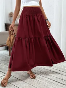 Women's high waist smocked tiered maxi skirt solid burgundy long casual skirt for daily wear.