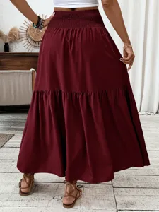 Burgundy tiered maxi skirt detail view showcasing the high waist smocked design and flowy drape.