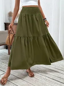 Close-up of the olive green tiered maxi skirt highlighting the high waist and hem.