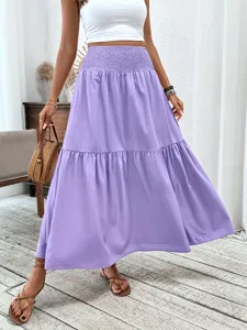 Close-up detail showing the high-waisted tiered maxi skirt in soft purple with graceful drape.