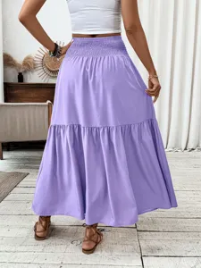Detailed back view of a women's high-waisted purple tiered long maxi skirt showcasing fit.