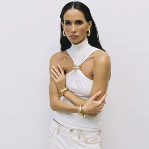 Detailed view of women's sleeveless halter top featuring a stylish front gold ring accent.
