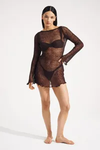 Close-up detail showcasing the fine knit texture and long sleeves of the brown beach dress.