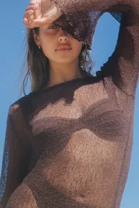 Detailed view of women's brown sheer knit beach dress, showing openwork texture and fabric.