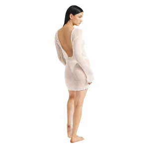 Women's white backless knit mini dress, sexy sheer beach cover-up, back view studio shot.
