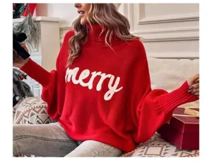 Close-up detail of the red oversized turtleneck batwing sweater with merry knit text.