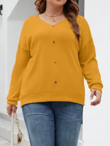 Close-up view of casual V-neck knitted sweater in solid yellow with front button details.